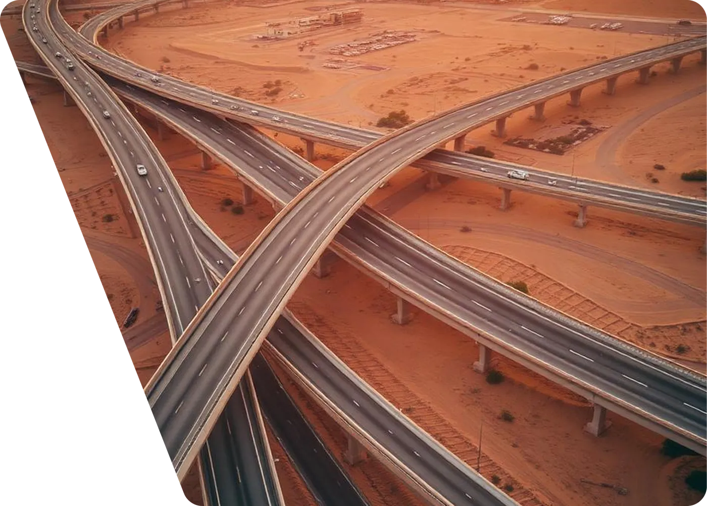 Aerial view of a multi-level highway interchange crossing the Saudi desert